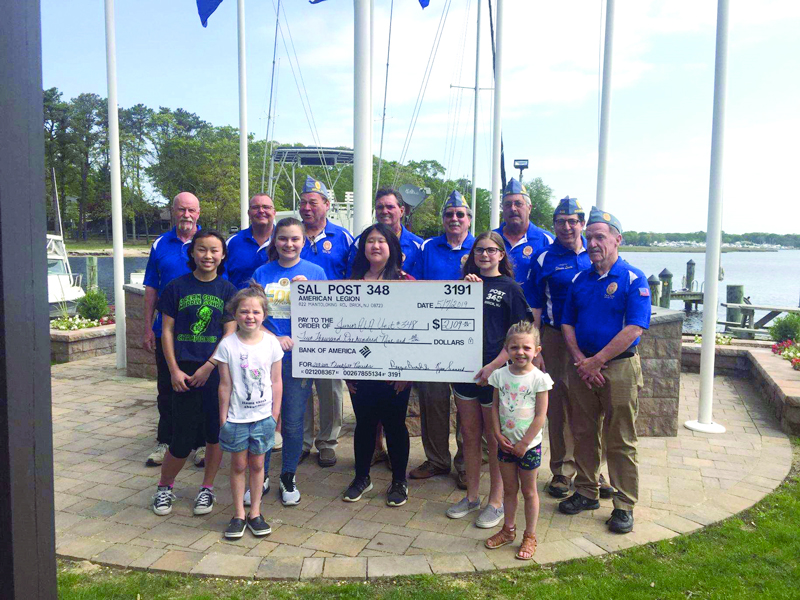 Legion Family members with large check