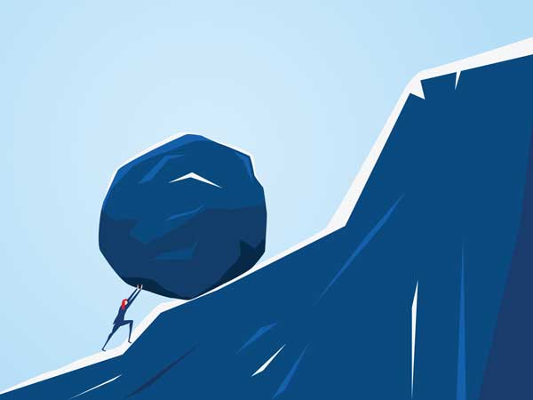 person pushing a rock up a mountain 