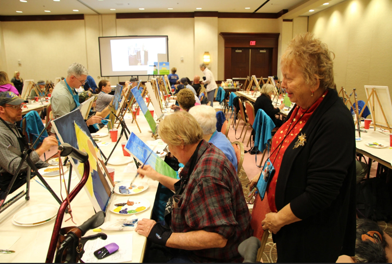 Caregiver Dolores Kostiw with her husband, Steve, at the National Veterans Creative Arts Festival in Des Moines, Iowa.