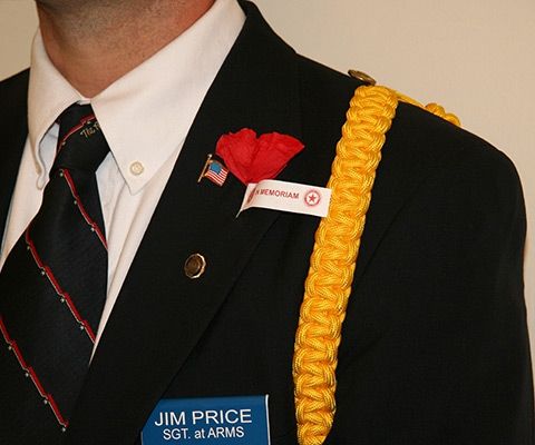 Man wearing a poppy flower